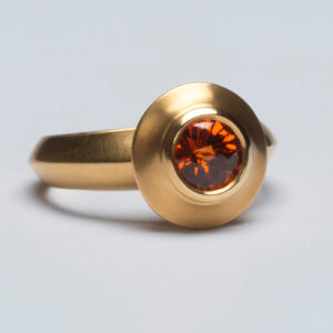 Ring in 22K Fairmined gold with a 1.0 ct. spessartite Garnet mined in Tanzania, $3,800; LFR Studios