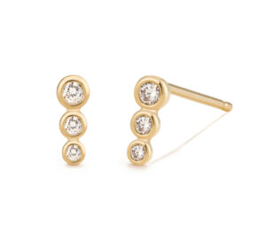 Graduated stud earrings in 14K recycled yellow gold with bezel-set Diamonds (0.056 ctw.), $300; Aurelie Gi