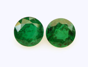 Matched pair round Zambian Emeralds (12.21 ctw.) measure 12.3 mm, have minor clarity enhancement, and come with a C. DUNAIGRE Switzerland lab report stating “vivid green,” $4,750 per carat; Shaun Gem International Ltd.
