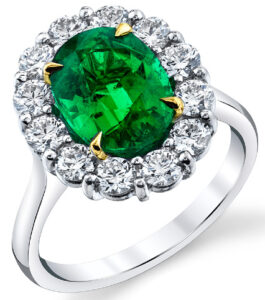 Ring in platinum and 18K yellow gold with a 3.11 ct. oval shaped Emerald and round shaped Diamonds (1.21 ctw.), May & Assoc