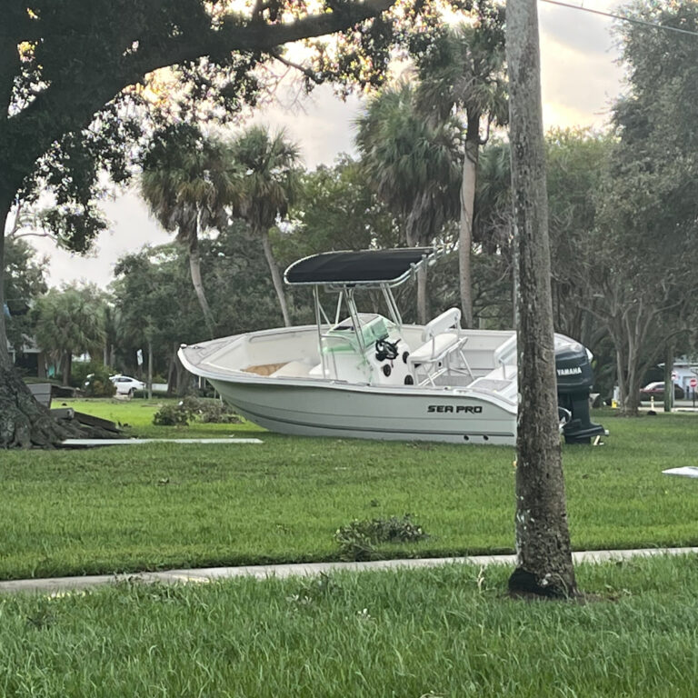 A boat in Saint Petersburg, Fla., landed on a lawn after Hurricane Helene.